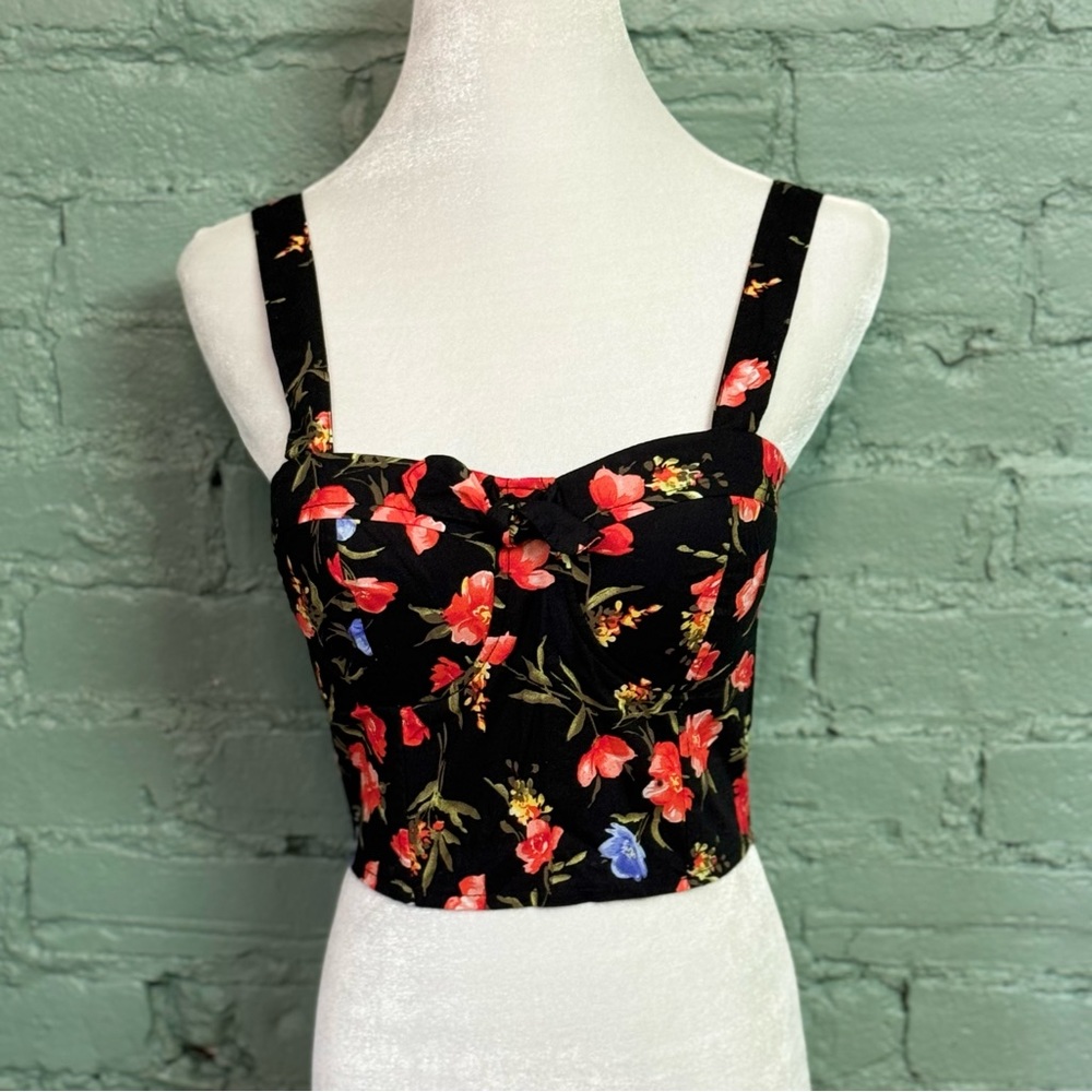 Cropped corset style floral tank with sweetheart neckline and bow detail.
